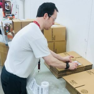 Employee places label on box.